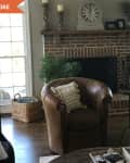 Before: Brick fireplace between two windows in living room