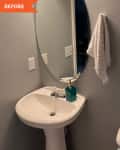 Before: gray bathroom with white sink and oval mirror