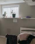Before: A gray bedroom with a short window