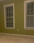 Before: an empty green room with blinds on the windows