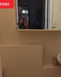 Before: a tan bathroom with a square mirror over a sink