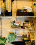 Before: white wire shelves holding kitchen items