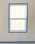 Before: a white room with a room and painters tape along the edges of the walls and windows