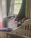 Before: Messy kid's room with bunk beds and a crib
