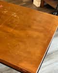 Before: Scratched wood-look table with black legs