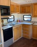 Before: a brown kitchen with wooden cabinets and a brown refrigerator