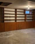 Before: an empty room with lots of wooden shelves