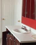 Before: Bathroom with red walls and brown vanity
