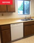 Dated kitchen with wooden cabinets, beige countertops, double sink, and dishwasher under a window.