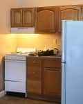Kitchen with wooden cabinets before renovation.
