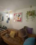 Living room with white walls , furniture, musical instruments before a painting project begins.