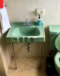 Vintage jade green bathroom before renovations.