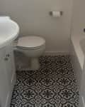 Before: Bathroom with black and tan floor tile