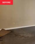 Before photo of studio apartment area that will become the bedroom. Empty room with gray walls, dirty floor