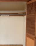 Closet before renovation. Plain, wood, nothing in it