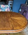 Oval wood dining table before makeover.