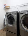 Before: a white laundry room with two silver machines