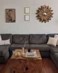 Before: a white living room with a large wrap around sofa