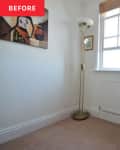 Floor lamp in corner of bedroom with artwork on wall before renovation.