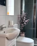 A bathroom with a black tile floor and shower.
