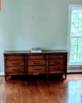 pale green home office with large windows, wood floors, and minimal furnishings before makeover