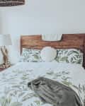 Wood headboard in bedroom before renovation.