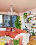Large pink sectional in living room with pink painted ceilings.