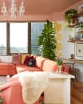 Pink sectional in living room with pink ceiling.