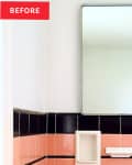 Pink tile with black tile border hangs on white bathroom with white sink and toilet.
