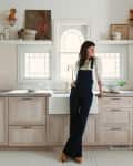 Leanne Ford leaning against kitchen cabinets with whitewash oak shaker doors.