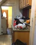 Kitchen with old wood cabinets in disarray before renovation