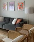 Art prints above sofa in living room before renovation.