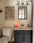 Art work mounted above toilet in bathroom before painting.