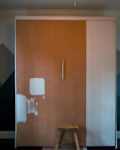 Paint swatches on closet door in bedroom before renovation.