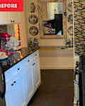 Kitchen with brown tile backsplash and white cabinets