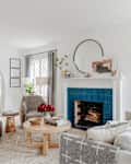 Teal tiles in front of fireplace in white living room before renovation.
