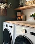 Floral arrangement in wicker basket in laundry room after renovation