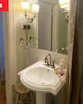Pedestal sink in bathroom before renovation.