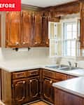 kitchen with dark wood cabinets and outdated wallpaper before makeover