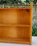Wooden bookshelf before redecorating.