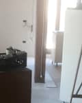 Room with ladder and appliances in it.