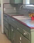 Tiled countertop in kitchen before renovation.