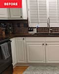 Dark countertops in kitchen with brown tile backsplash before renovation