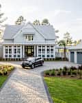 Car in driveway of HGTV dream home.