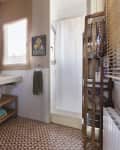 A light brown bathroom with brick walls and a tiled floor