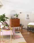a bedroom with a pink accent chair