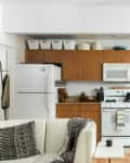 A small kitchen that uses the space above the cabinets for storage