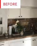 Small kitchen with white cabinets, brown tile backsplash, dish rack, and potted flowers near the sink.