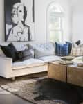 White living room with sectional sofa and black and white art