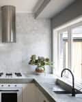an industrial style kitchen with a gray and white hexagonal backsplash